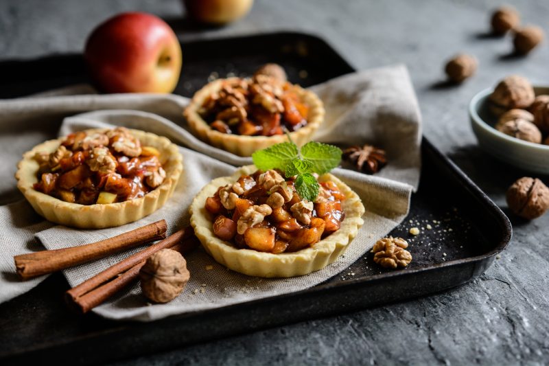 Delicious tartlets filled with caramelized apple pieces, cinnamon and walnuts