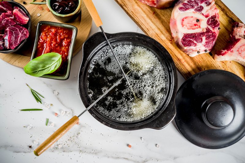 Beef meat fondue, with different sauces, top view copy space